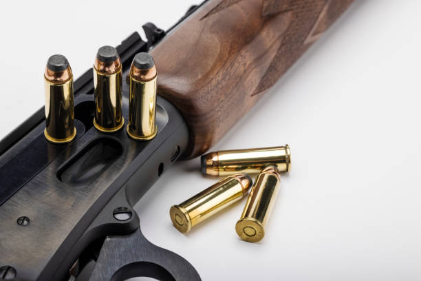 istock Classic gun , .44 Lever action rifle gun with bullets on white background 1338000039