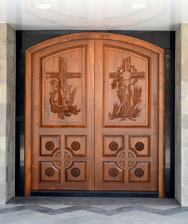 Wooden detail on the door of the main entrance to the Don Bosco Church Location: Nashik, Maharashtra, India. Date - August 29 2021