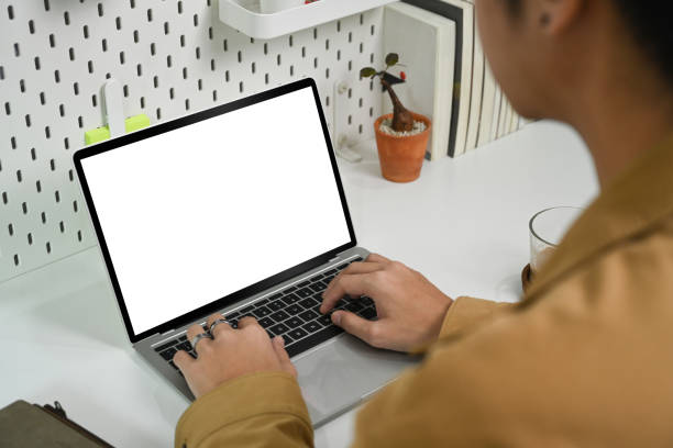 istock View over businessman shoulder working with laptop computer. 1338002099