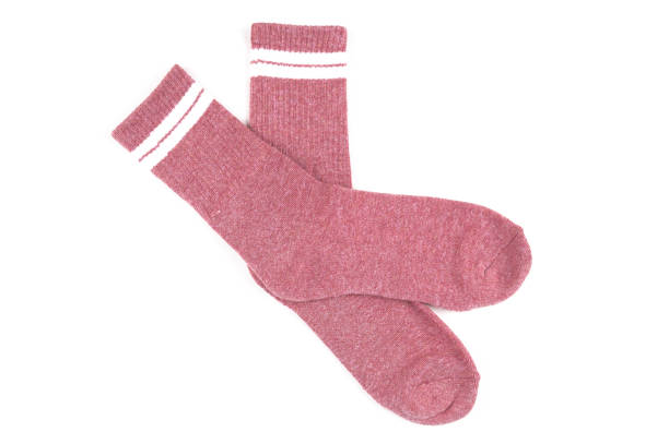 istock Pair of pink socks isolated on white, top view 1338004376