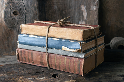 a stack of old books tied with twine