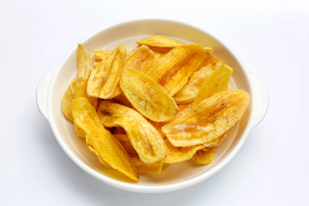 istock Banana slice chips in white bowl on white background 1338006172