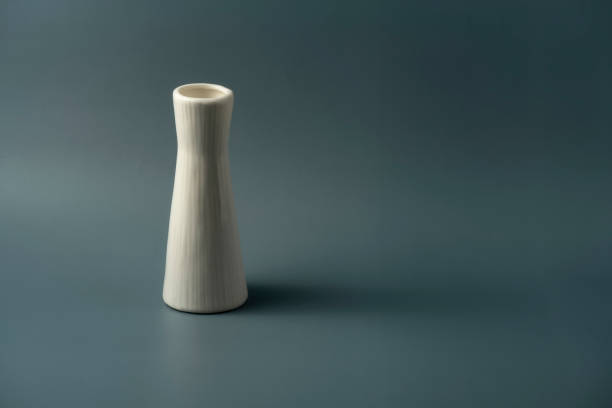 istock Still life: a ceramic bottle on a dark green background 1338006301