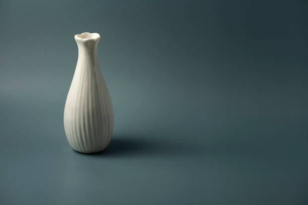 istock Still life: a ceramic bottle on a dark green background 1338006324