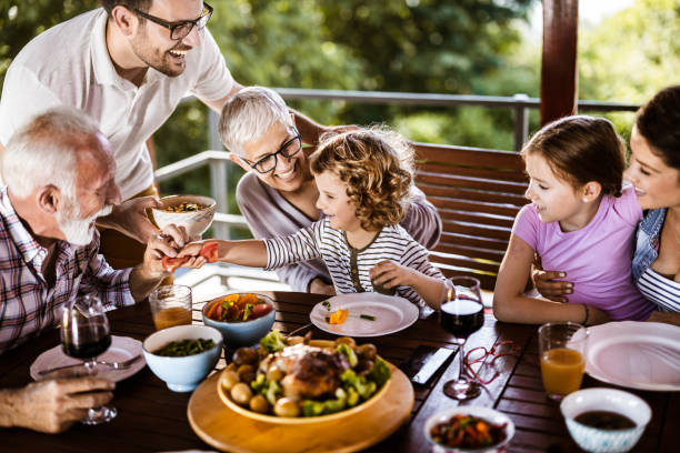 istock Happy multi-generation family talking while having lunch on a terrace. 1338008822
