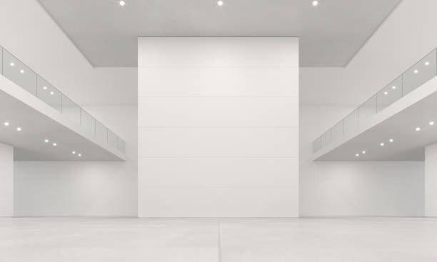 Large empty museum hall and exhibition venue with white walls illuminated by bright light. White painted surfaces and concrete ceiling. Museum space with no people, copy space. Digitally generated image.