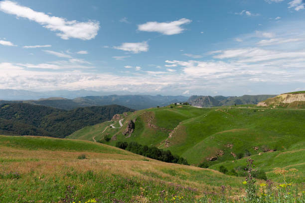 istock Panoramic view of green hills and blue mountains 1338010378