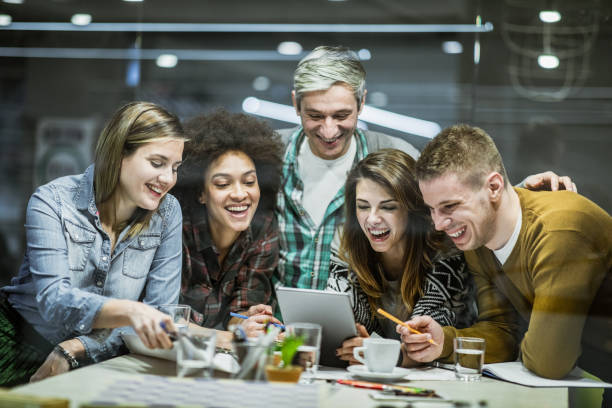 istock Group of happy freelance workers working on touchpad in the office. 1338010396