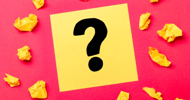 istock Questions Mark ( ? ) word on yellow note with crumbled paper on red background 1338011709