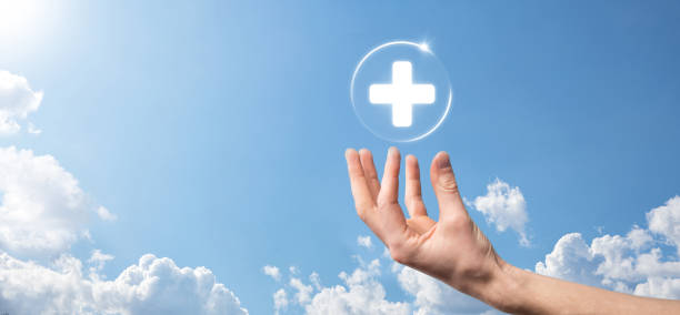 istock Businessman hold virtual plus medical network connection icons. Covid-19 pandemic develop people awareness and spread attention on their healthcare. 1338012128