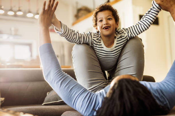 istock Joyful black boy having fun with his single father at home. 1338013007