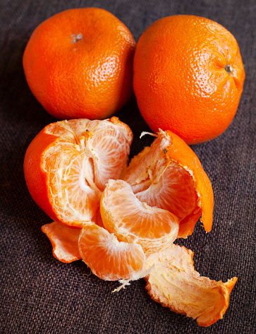 Nartjie or Tangerine, peeled with rustic background