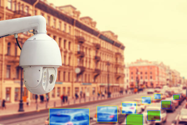 istock The concept of video surveillance and security technologies. Surveillance camera on the background of the city road with cars. Definition area. Tint 1338013372