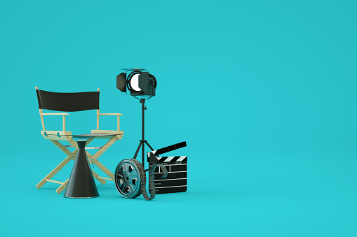 3d rendering, director's chair, film reel, film slate, movie clapper, cinematography concept. Blue background.