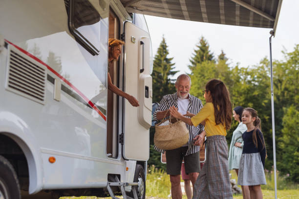istock Multi-generation family unpacking and talking by car, caravan holiday trip. 1338015920