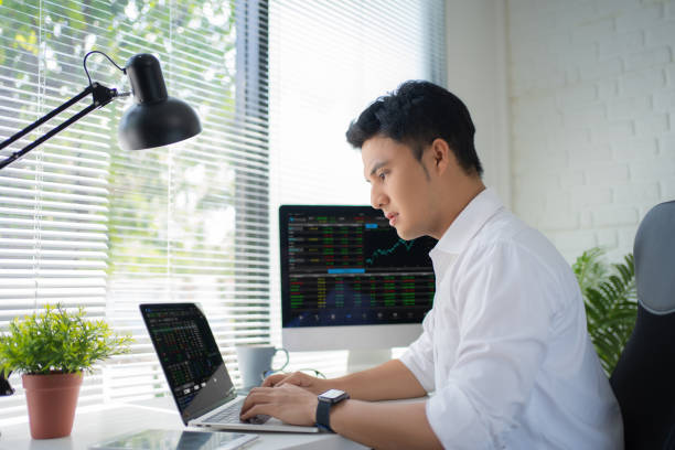 istock Busy young asian modern man in formalwear working using computers while sitting in the office. 1338016719
