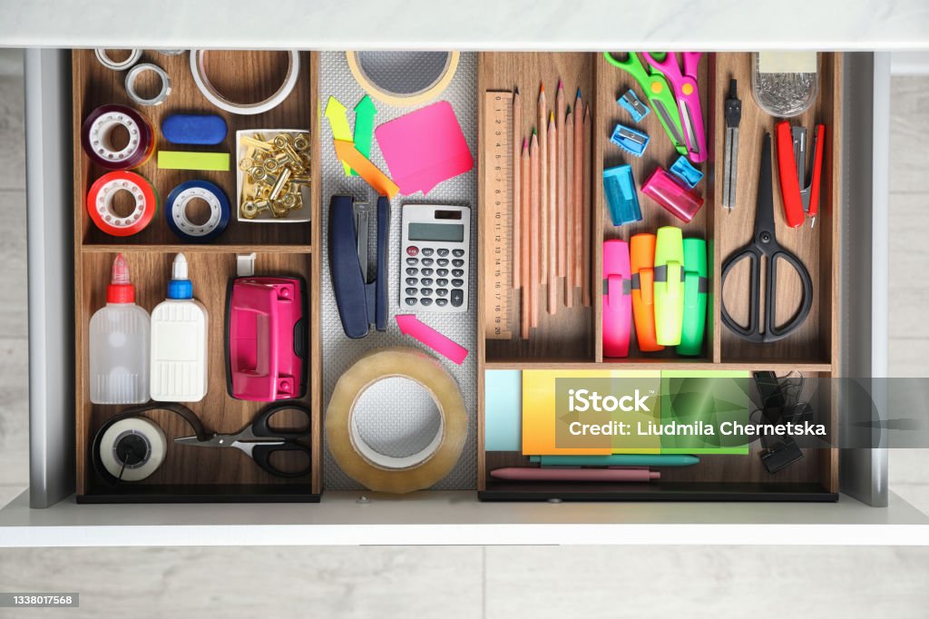 Different stationery in open desk drawer, top view Office Supply Stock Photo