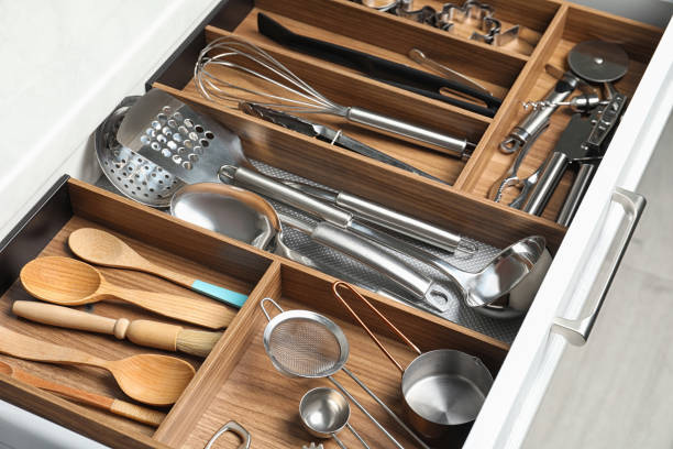 istock Different utensils in open desk drawer indoors, closeup 1338017946