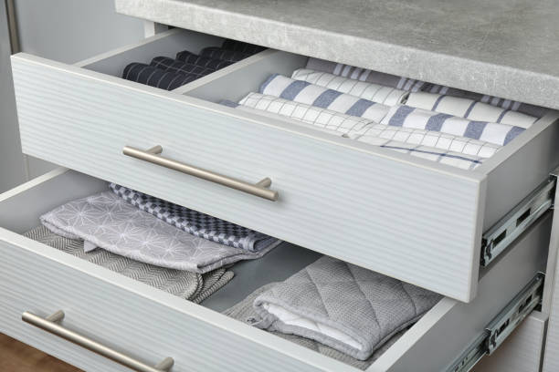 istock Open drawers with folded towels and oven mittens. Order in kitchen 1338017990