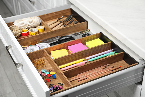 Different stationery in open desk drawer indoors
