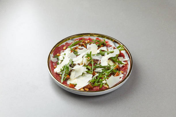 Beef Carpaccio with Rocket and Parmesan Cheese Beef Carpaccio with Rocket and Parmesan Cheese. High quality photo carpaccio parmesan cheese beef raw stock pictures, royalty-free photos & images