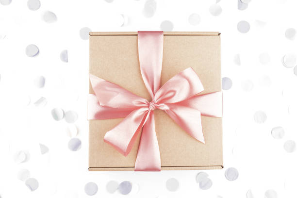 istock present gift box with pink bow with festive confetti. 1338022000