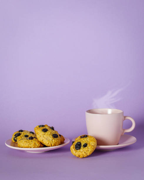 cookies and cup of coffee on color background, copy space