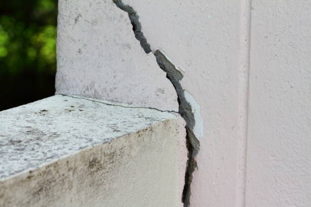 istock Pink cement wall background cracked and peeling paint. 1338023813