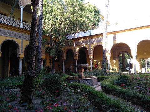 Image of a courtyard with gardens and a fountain