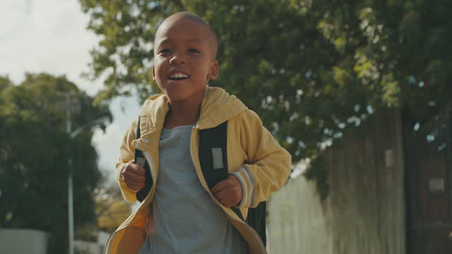 4k video footage of an adorable little boy walking in the street