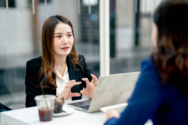 istock Business women Making smart Talk about work outside the cafe seriously. 1338027521