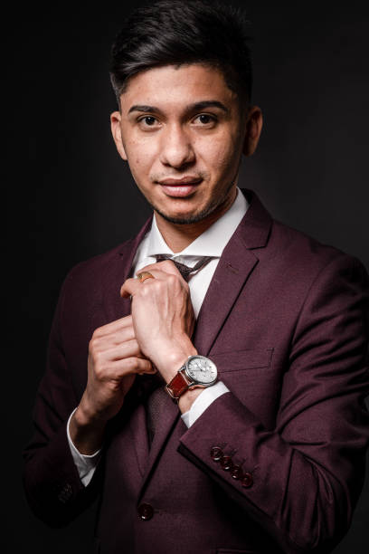 istock Latin man in suit on black background, portrait 1338027788