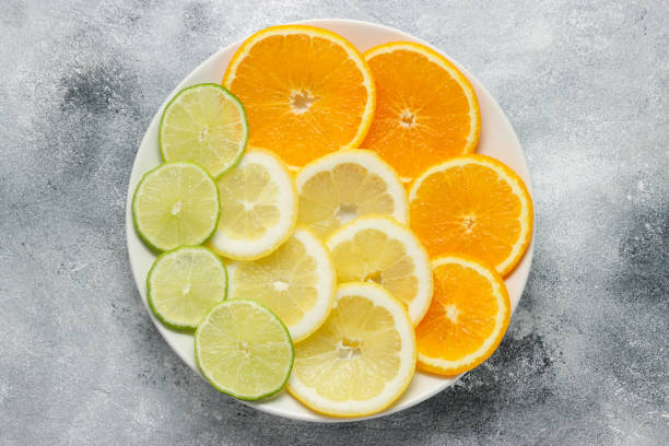 istock sliced composition with oranges, limes and lemons at the plat 1338028095