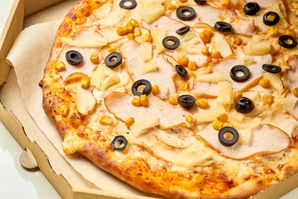 istock Chicken and pineapple pizza, sauce and melted cheese, crispy sides isolated on white background 1338029461