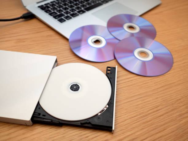 DVD drive connected to a laptop DVD drive connected to a laptop dvd player stock pictures, royalty-free photos & images