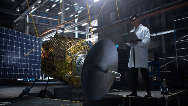 istock Industrial Engineer Working on Artificial Satellite Construction. Aerospace Agency: Scientist Using Laptop Computer to Develop Spacecraft for Space Exploration and Data Communication. 1338031095