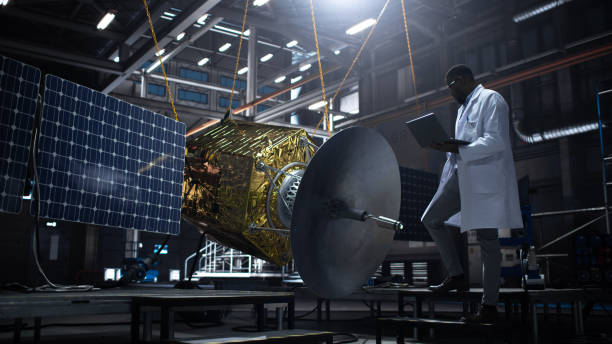 istock Industrial Engineer Working on Artificial Satellite Construction. Aerospace Agency: African American Scientist Using Tablet Computer to Develop Spacecraft for Space Exploration and Data Communication. 1338031097