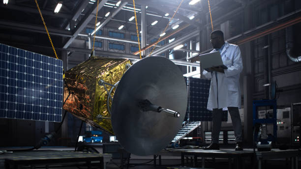 istock Industrial Engineer Working on Artificial Satellite Construction. Aerospace Agency: African American Scientist Using Tablet Computer to Develop Spacecraft for Space Exploration and Data Communication. 1338031114