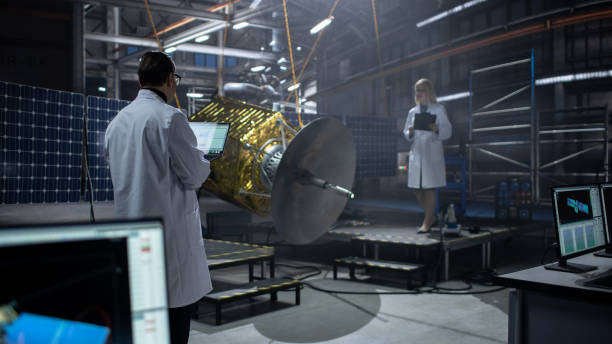 istock Engineer and Technician Working on Satellite Construction. Aerospace Agency: Diverse Team of Scientists Using Technological Equipment and Laptop Computer to Develop Spacecraft for Space Exploration. 1338031141