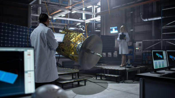 istock Engineer and Technician Working on Satellite Construction. Aerospace Agency: Diverse Team of Scientists Using Technological Equipment and Laptop Computer to Develop Spacecraft for Space Exploration. 1338031154
