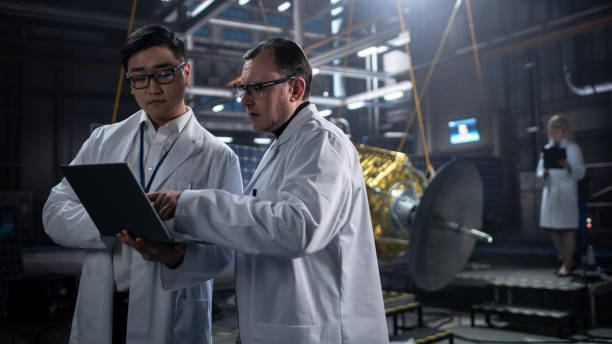 istock Engineer and Technician Working on Satellite Construction. Aerospace Agency: Diverse Team of Scientists Using Technological Equipment and Laptop Computer to Develop Spacecraft for Space Exploration. 1338031335