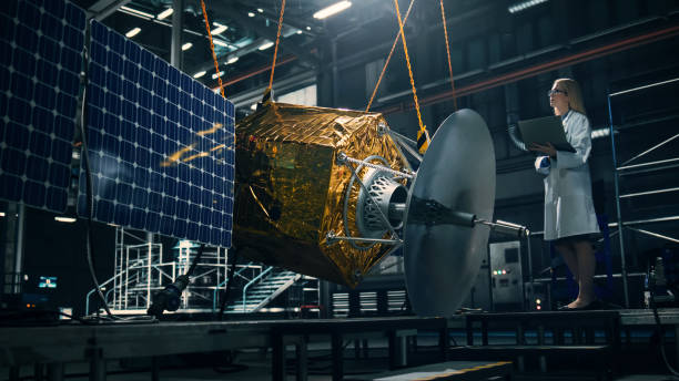istock Industrial Engineer Working on Artificial Satellite Construction. Aerospace Agency: Female Scientist Using Laptop Computer to Develop Spacecraft for Space Exploration and Data Communication. 1338031701