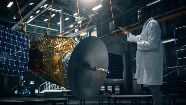 istock Industrial Engineer Working on Artificial Satellite Construction. Aerospace Agency: African American Scientist Using Tablet Computer to Develop Spacecraft for Space Exploration and Data Communication. 1338031703