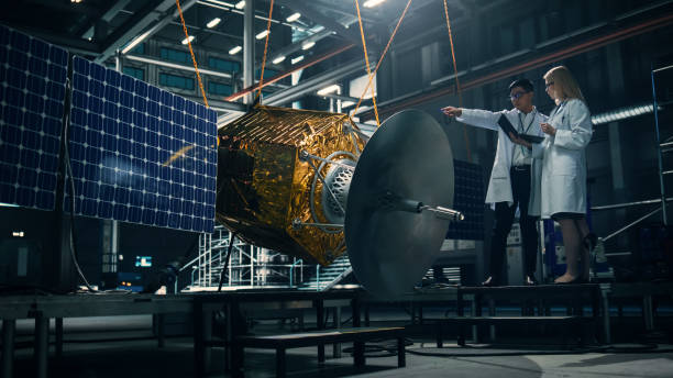 istock Engineer and Technician Working on Satellite Construction. Aerospace Agency: Diverse Team of Scientists Using Technological Equipment and Laptop Computer to Develop Spacecraft for Space Exploration. 1338031708