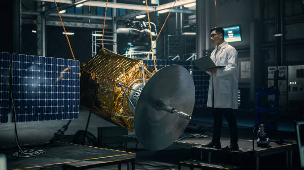 istock Industrial Engineer Working on Artificial Satellite Construction. Aerospace Agency: Scientist Using Laptop Computer to Develop Spacecraft for Space Exploration and Data Communication. 1338031756