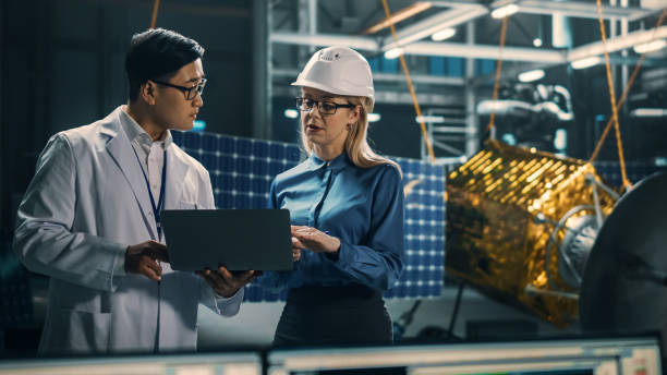 istock Engineer and Technician Working on Satellite Construction. Aerospace Agency: Diverse Team of Scientists Using Technological Equipment and Laptop Computer to Develop Spacecraft for Space Exploration. 1338031873