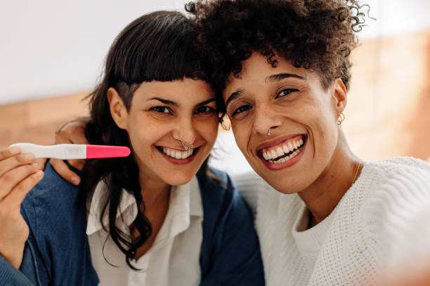 istock Ecstatic female couple taking a selfie with their positive pregn 1338033930