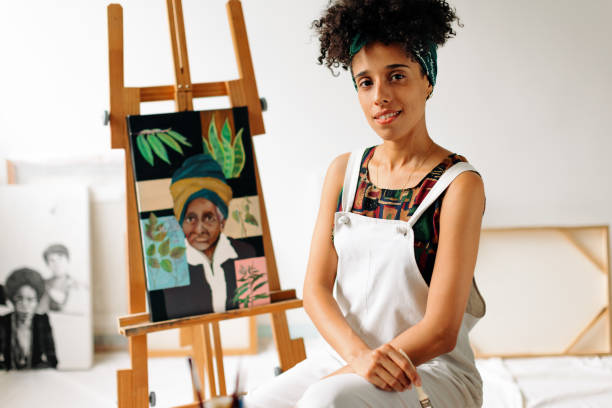 istock Confident young female painter sitting in her studio 1338034060