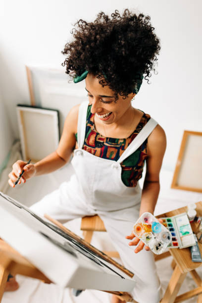 istock Cheerful female painter working on a new project in a workshop 1338034187