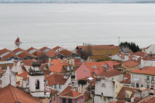Lisbon, Portugal; March 23 2013: Portuguese landscape with houses and boat in the background